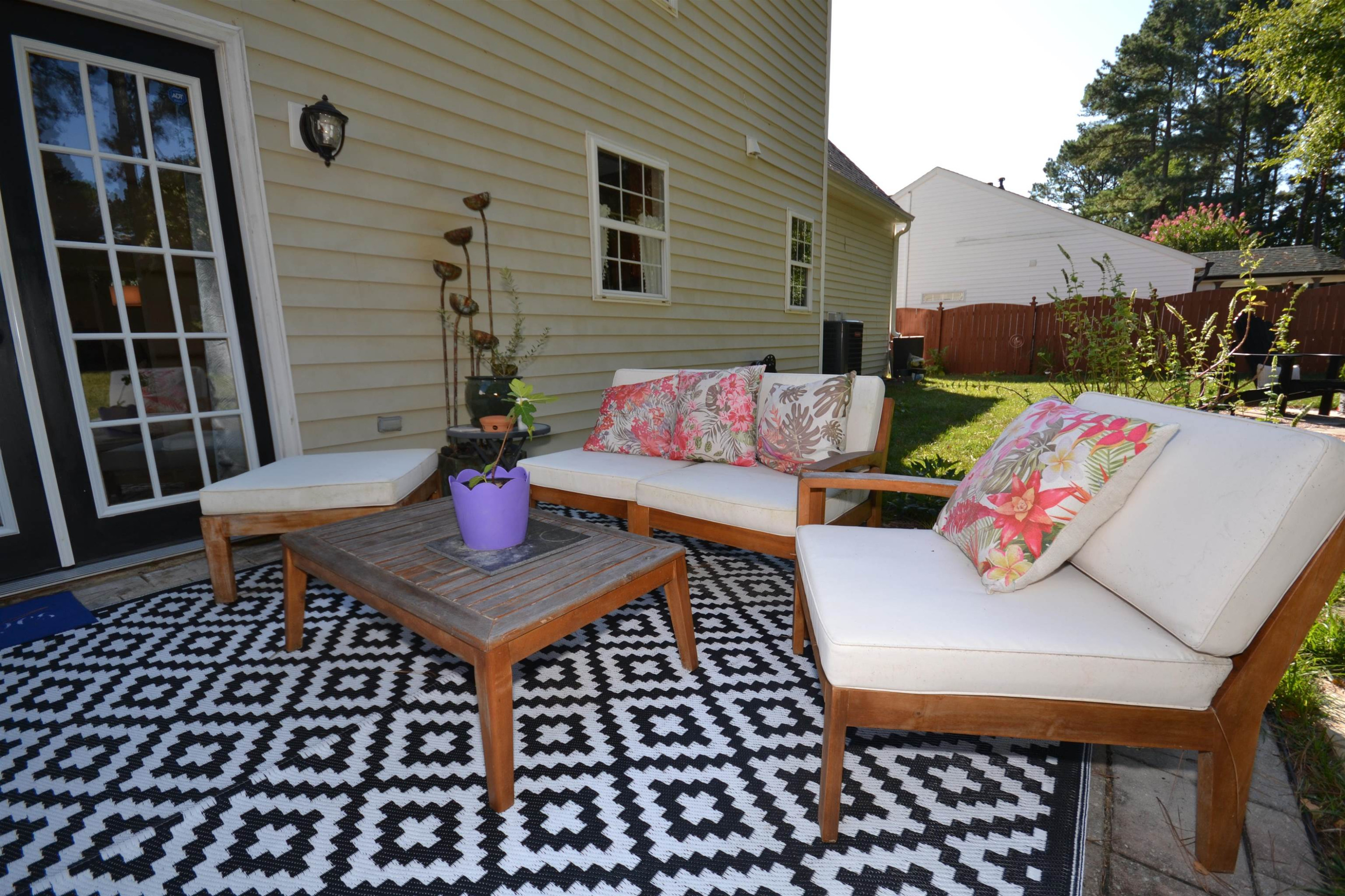 5501 Cardinal Grove Boulevard Raleigh, NC 27616 - Photo 24 of 37 a view of a patio with a table and chairs