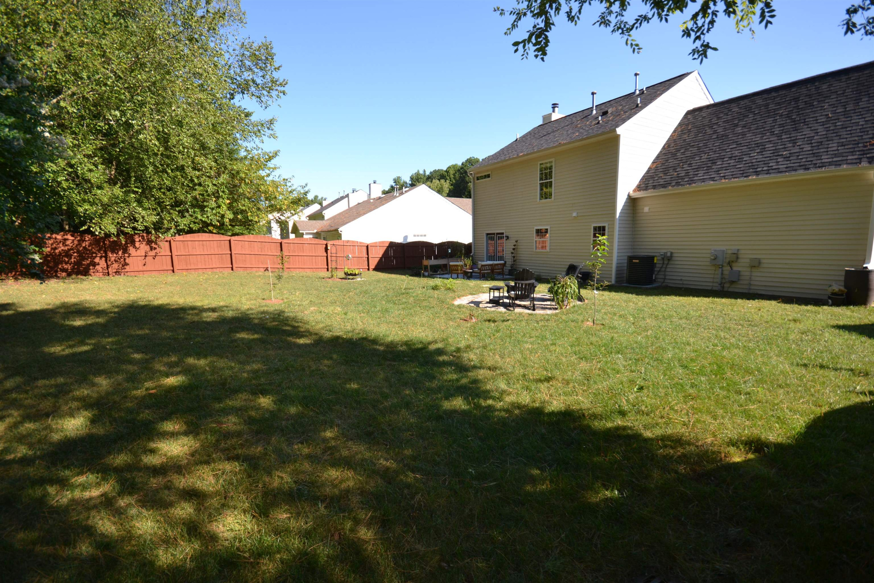 5501 Cardinal Grove Boulevard Raleigh, NC 27616 - Photo 27 of 37 a backyard of a house with yard and outdoor seating