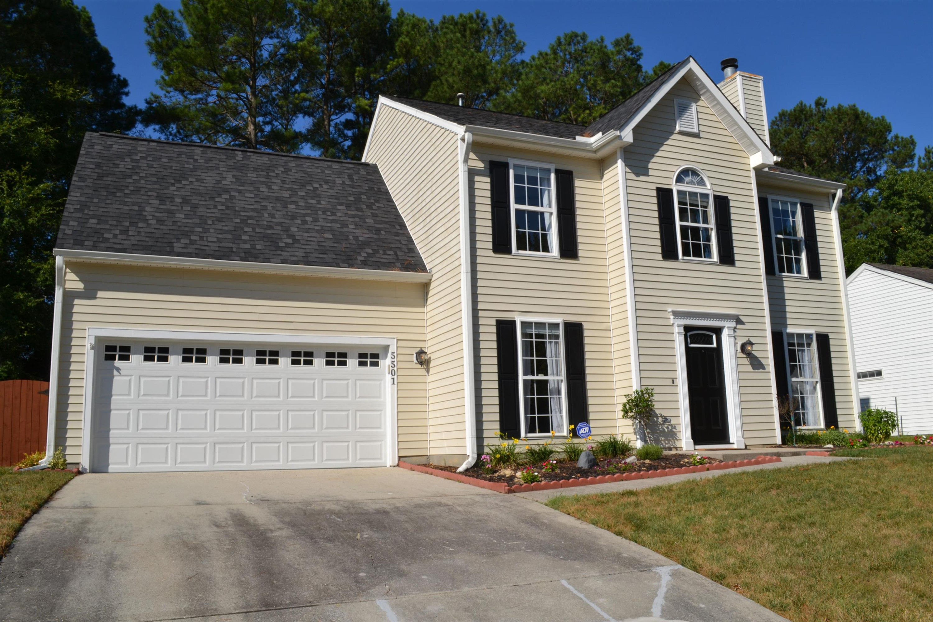 5501 Cardinal Grove Boulevard Raleigh, NC 27616 - Photo 32 of 37 a front view of a house with a yard and garage
