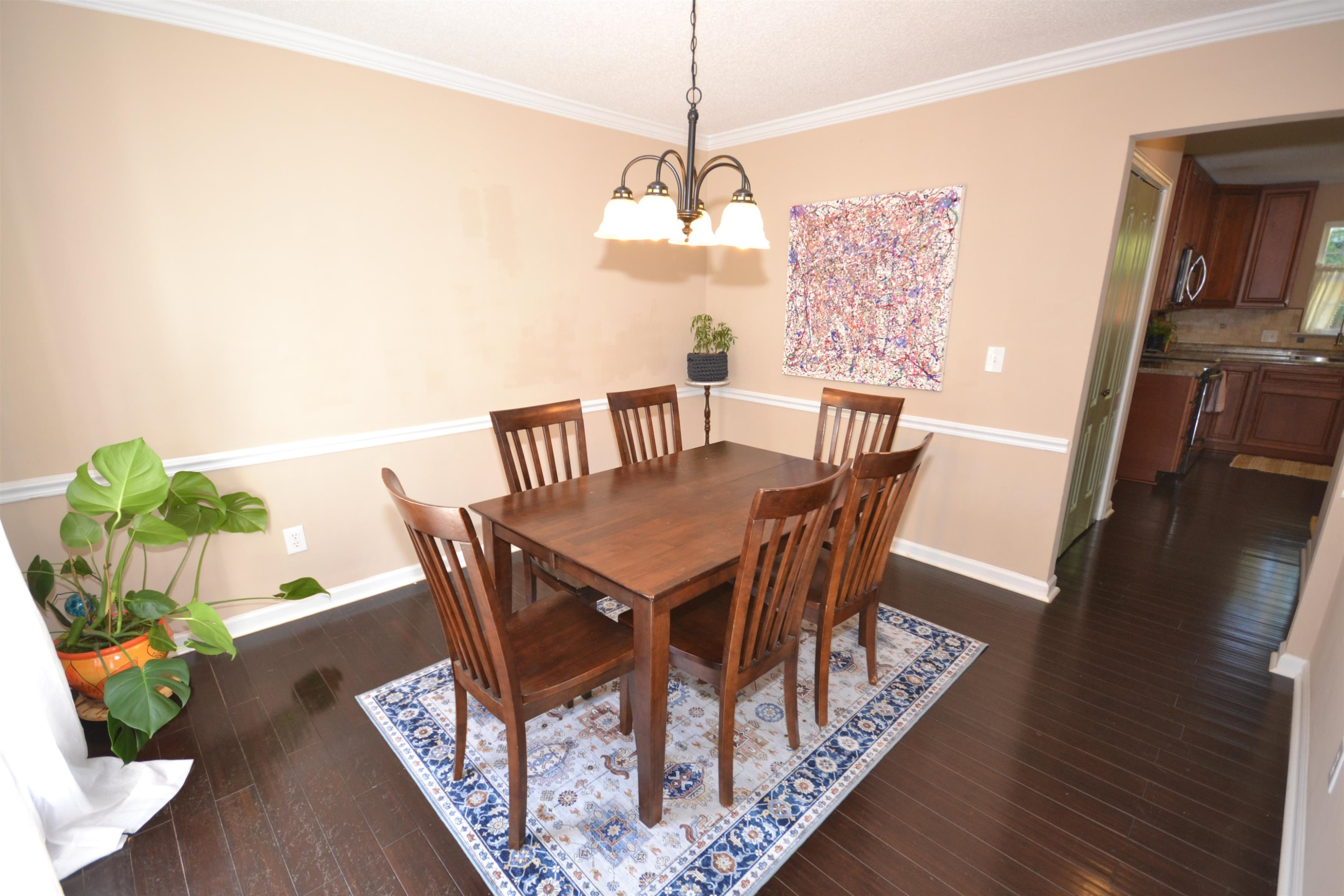 5501 Cardinal Grove Boulevard Raleigh, NC 27616 - Photo 5 of 37 a view of a dining room with furniture wooden floor and a chandelier