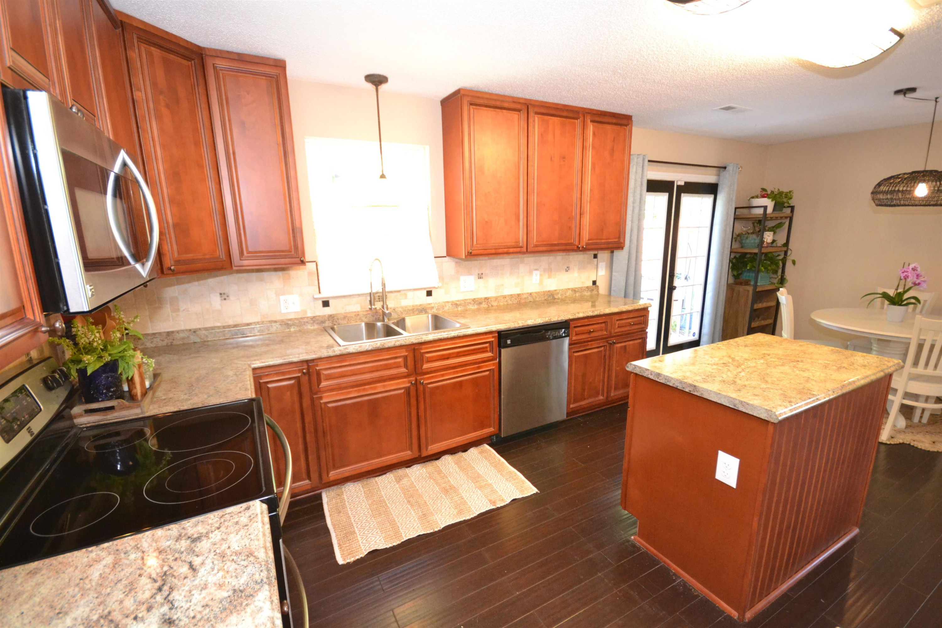 5501 Cardinal Grove Boulevard Raleigh, NC 27616 - Photo 8 of 37 a kitchen with a sink stove and cabinets