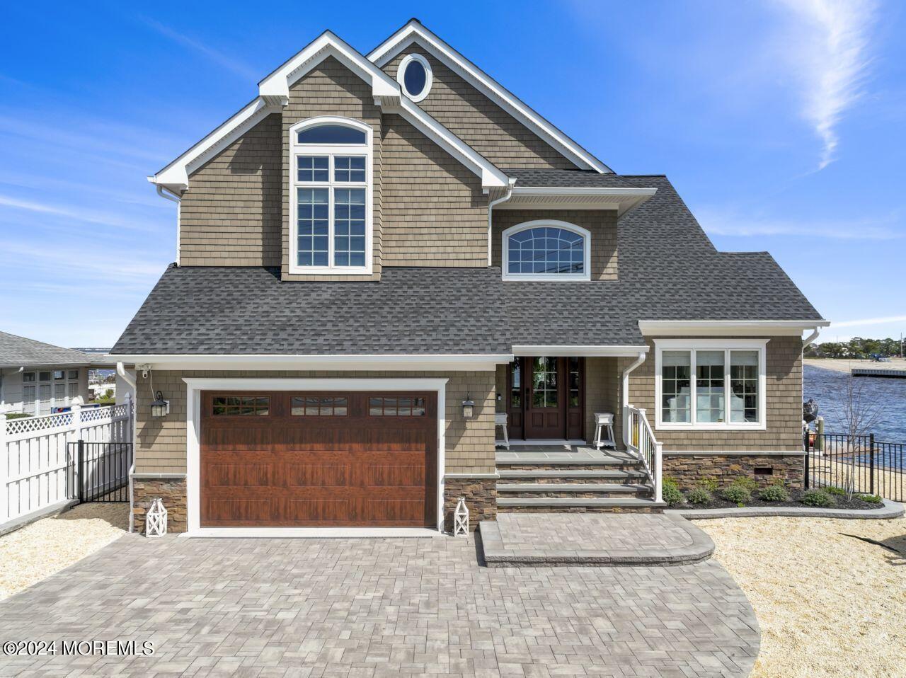 1 Pershing Boulevard Lavallette, NJ 08735 - Photo 1 of 61 a front view of a house with a yard and garage