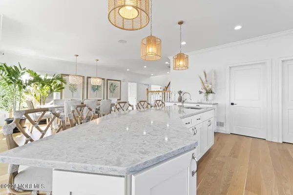 a kitchen with stainless steel appliances white cabinets a stove a sink and a refrigerator