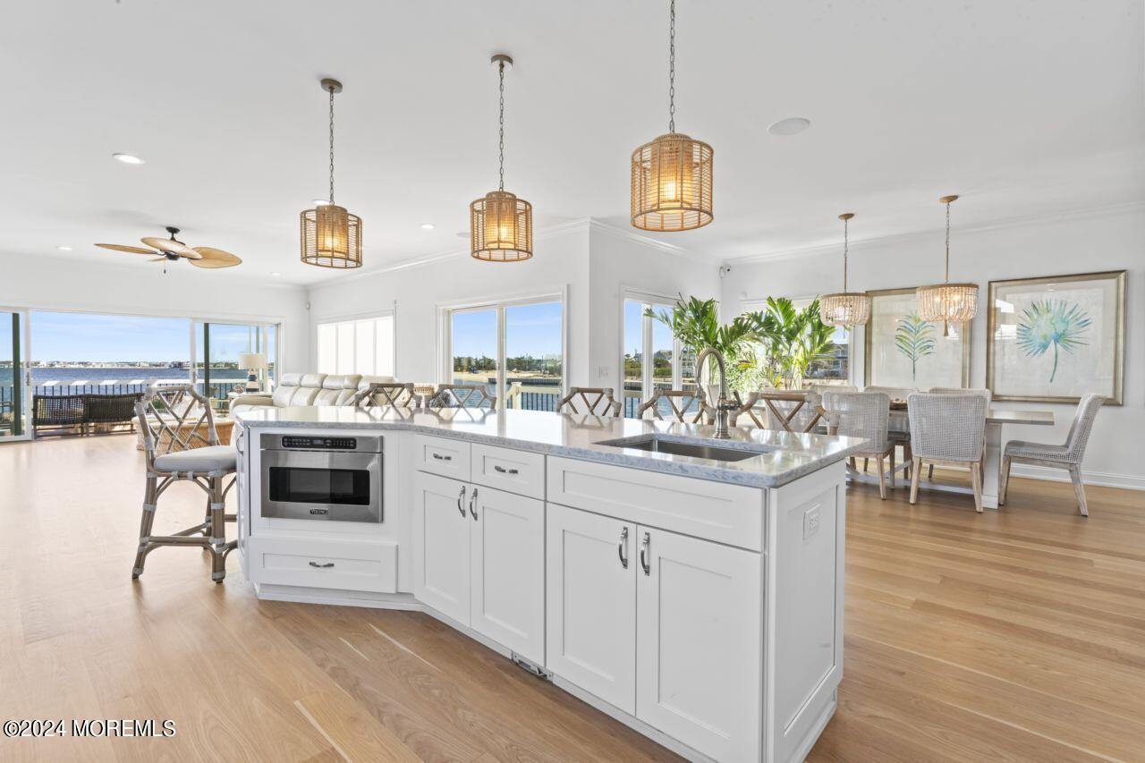 1 Pershing Boulevard Lavallette, NJ 08735 - Photo 13 of 61 a kitchen with stainless steel appliances kitchen island granite countertop a stove a sink and a refrigerator