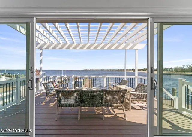 a living room with furniture kitchen view and a flat screen tv