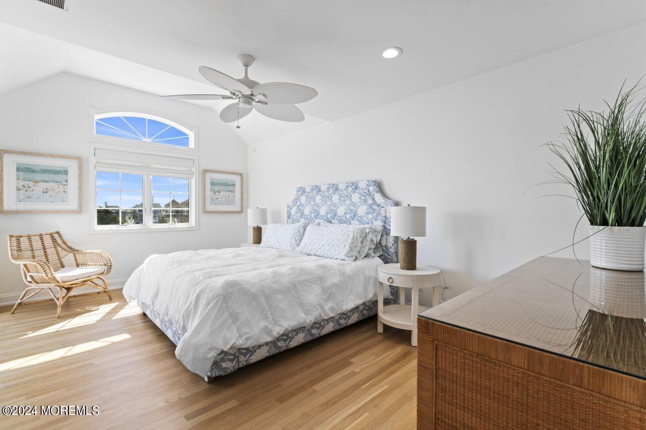1 Pershing Boulevard Lavallette, NJ 08735 - Photo 25 of 61 a bedroom with a large bed and a chandelier