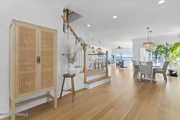 a dining room with furniture a chandelier and wooden floor
