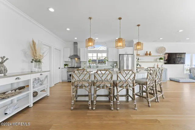 an open kitchen with a sink and breakfast area