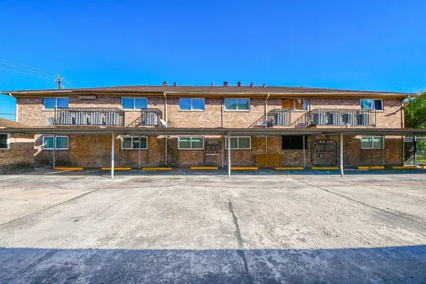 a front view of a building with a garden