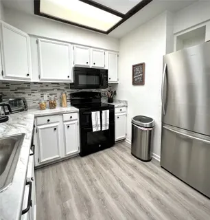 a kitchen with cabinets and appliances