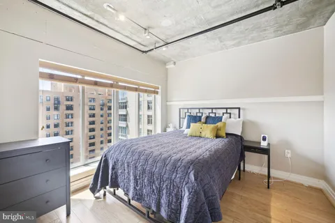 a bedroom with a large bed and a large window