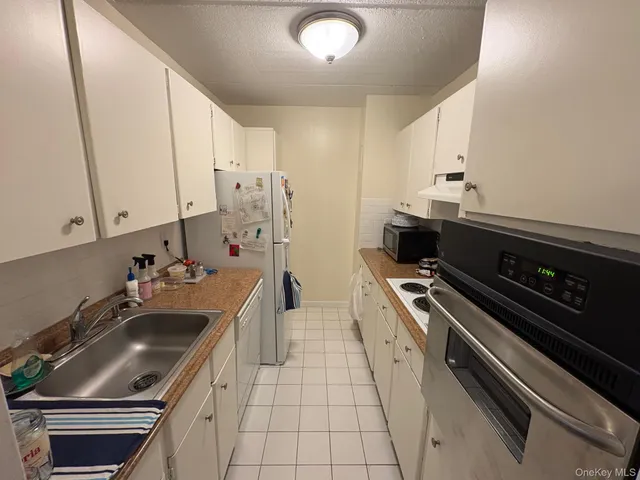 a kitchen that has a sink and a stove