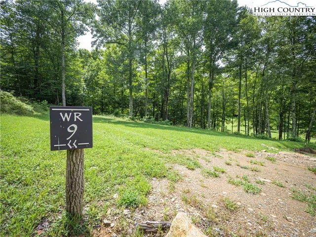 a street sign on a sidewalk next to a road
