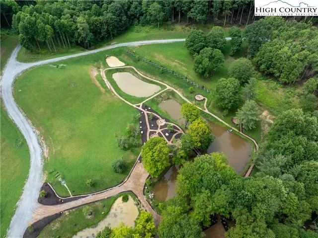 an aerial view of a golf course with swimming pool