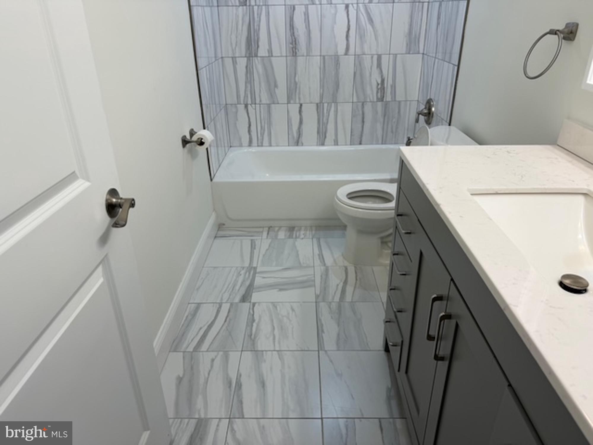 6409 63rd Place Riverdale, MD 20737 - Photo 18 of 22 a bathroom with a sink and a tub