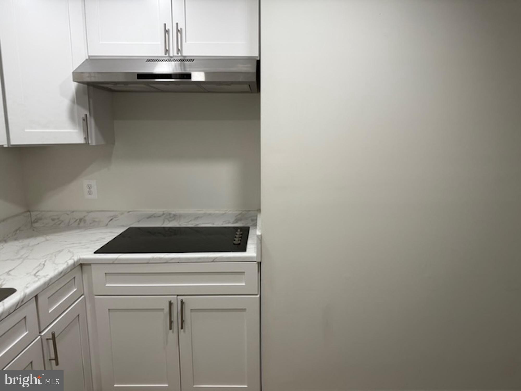 6409 63rd Place Riverdale, MD 20737 - Photo 19 of 22 a kitchen with a sink and cabinets