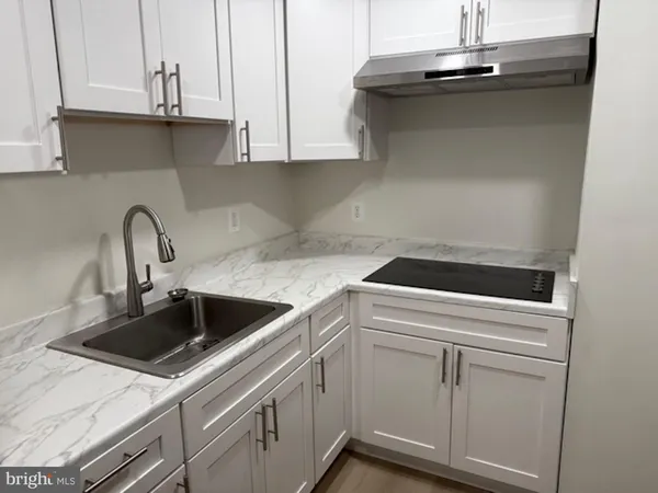 a kitchen with white cabinets and white appliances