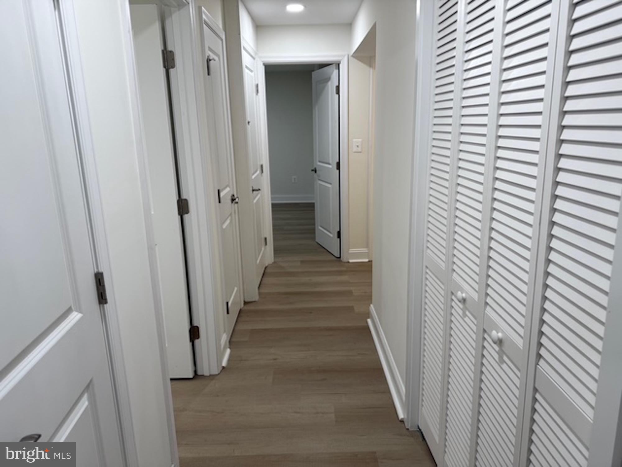 6409 63rd Place Riverdale, MD 20737 - Photo 21 of 30 a view of a hallway with wooden floor and staircase