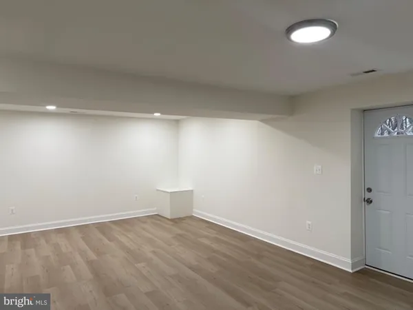 a view of an empty room with a fan