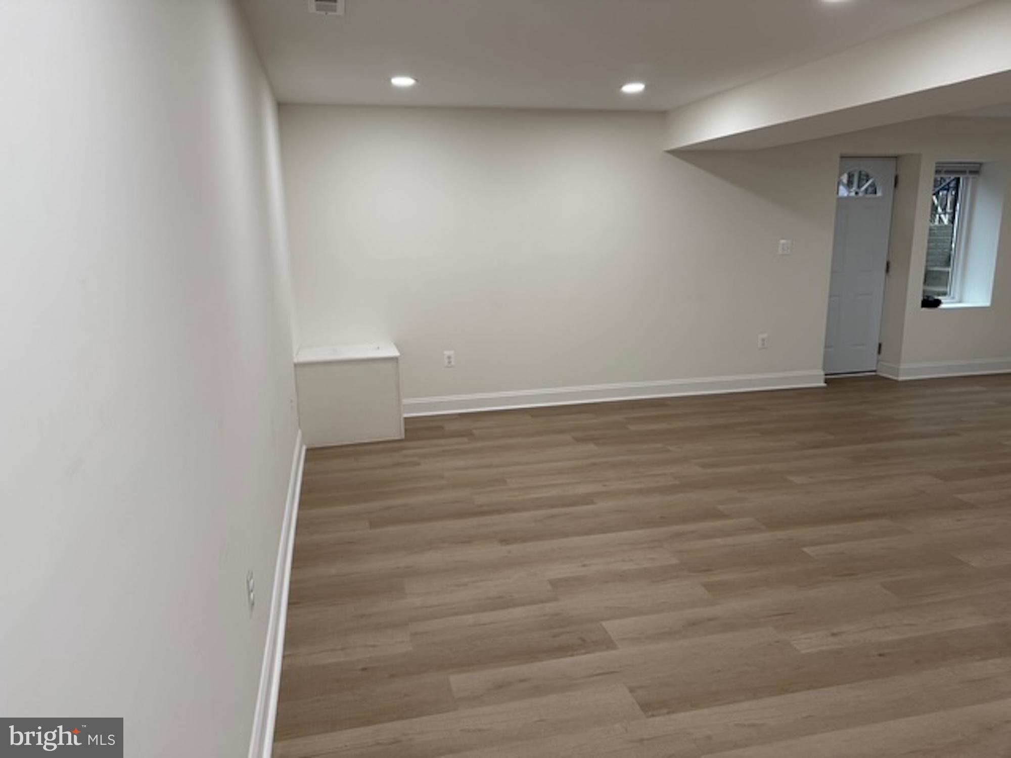 6409 63rd Place Riverdale, MD 20737 - Photo 8 of 22 a view of an empty room with wooden floor