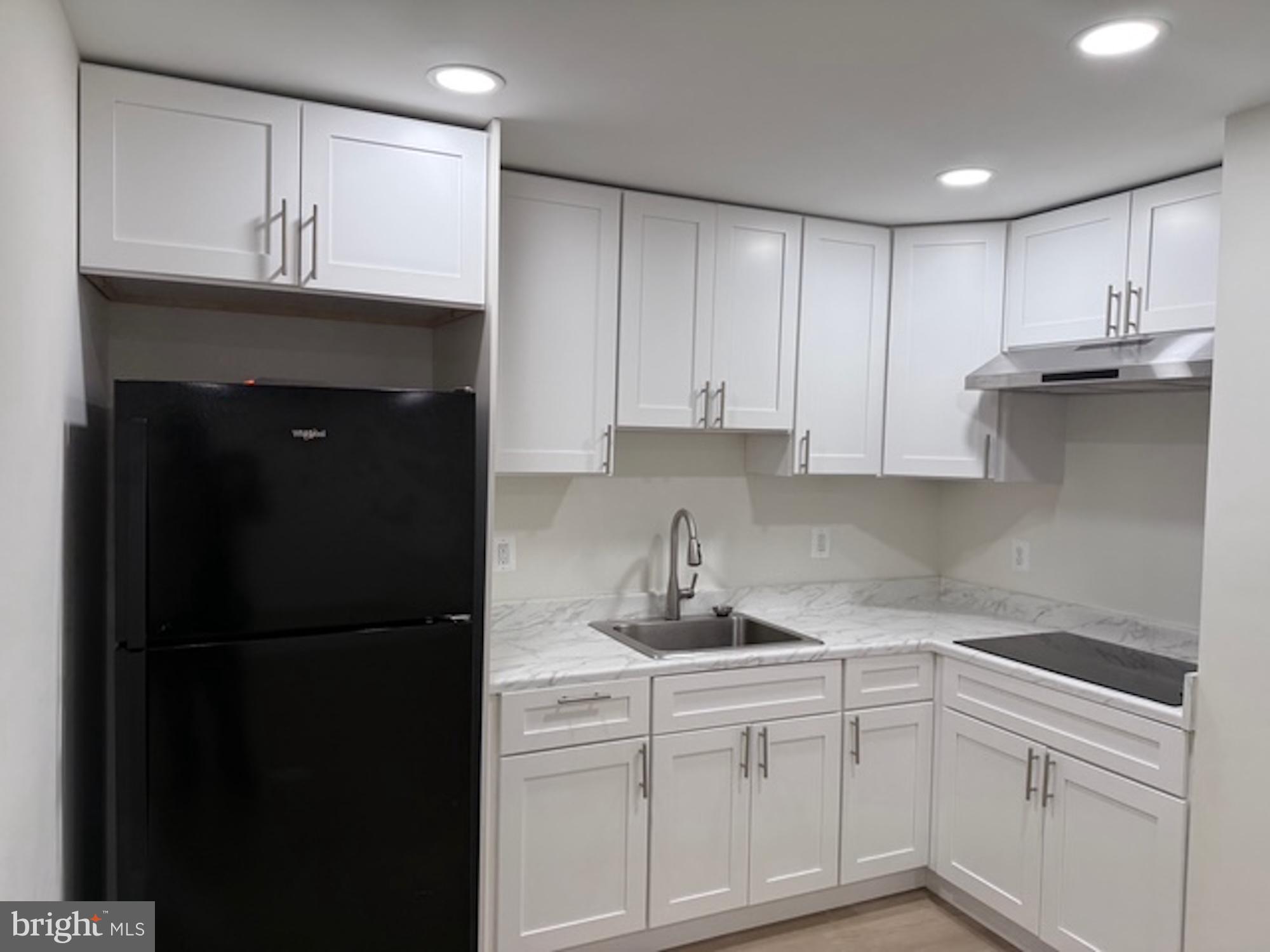 6409 63rd Place Riverdale, MD 20737 - Photo 10 of 22 a kitchen with a sink and cabinets