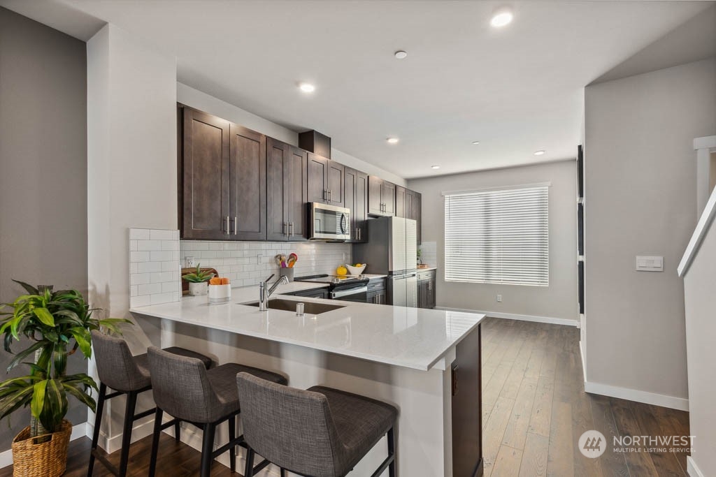 9616 19th Avenue Southeast, Unit E Everett, WA 98208 - Photo 6 of 17 a kitchen with a table and chairs in it