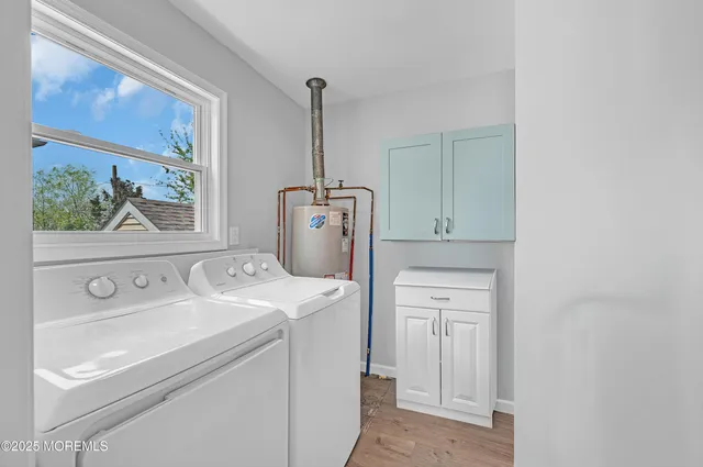 a kitchen with stainless steel appliances kitchen island granite countertop a dining table chairs and a refrigerator