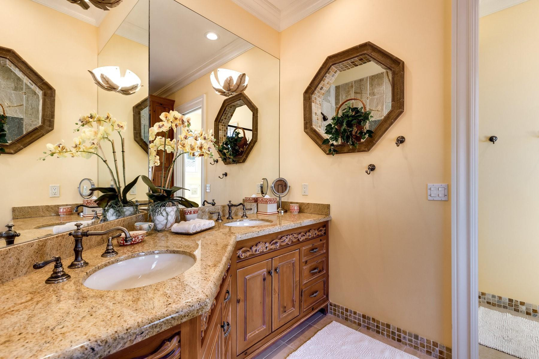 4089 Southeast Old St Lucie Boulevard Stuart, FL 34996 - Photo 66 of 99 a bathroom with a granite countertop sink and a mirror