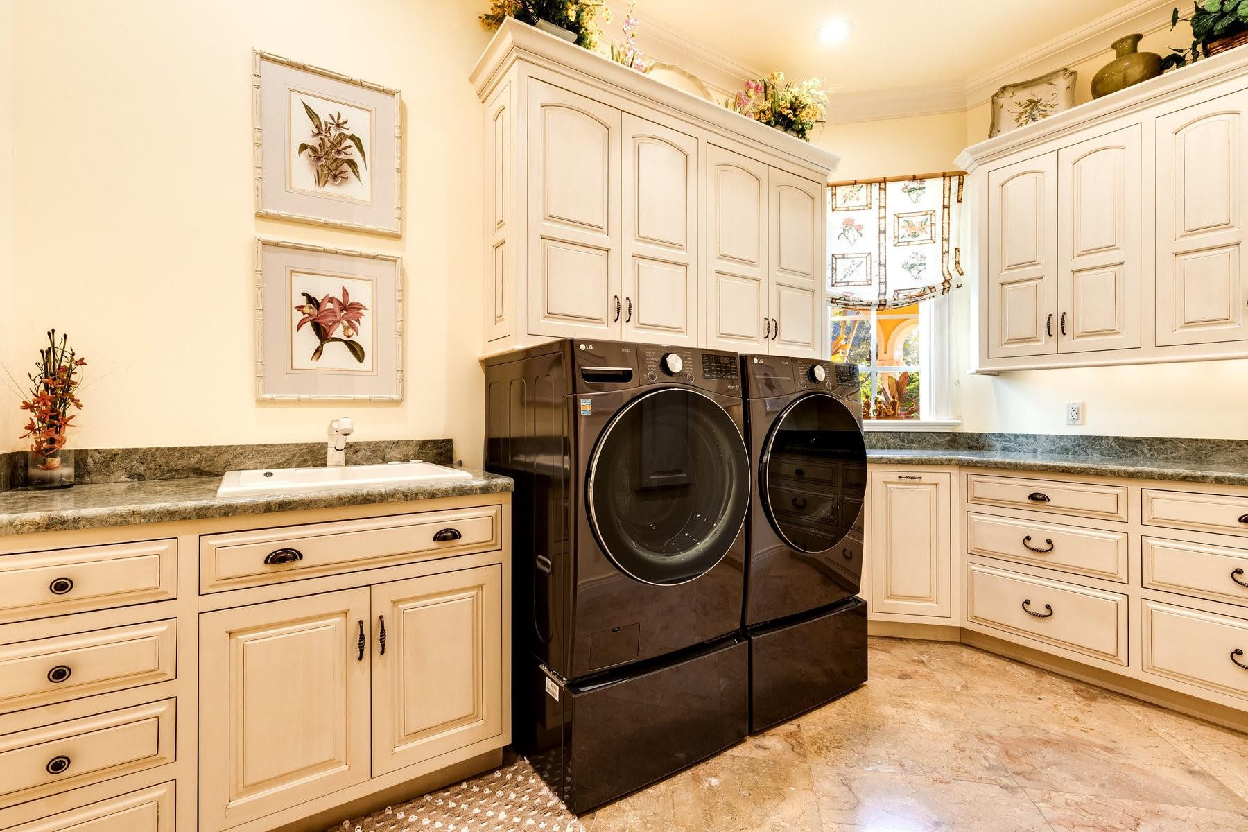 4089 Southeast Old St Lucie Boulevard Stuart, FL 34996 - Photo 79 of 99 a utility room with cabinets washer and dryer