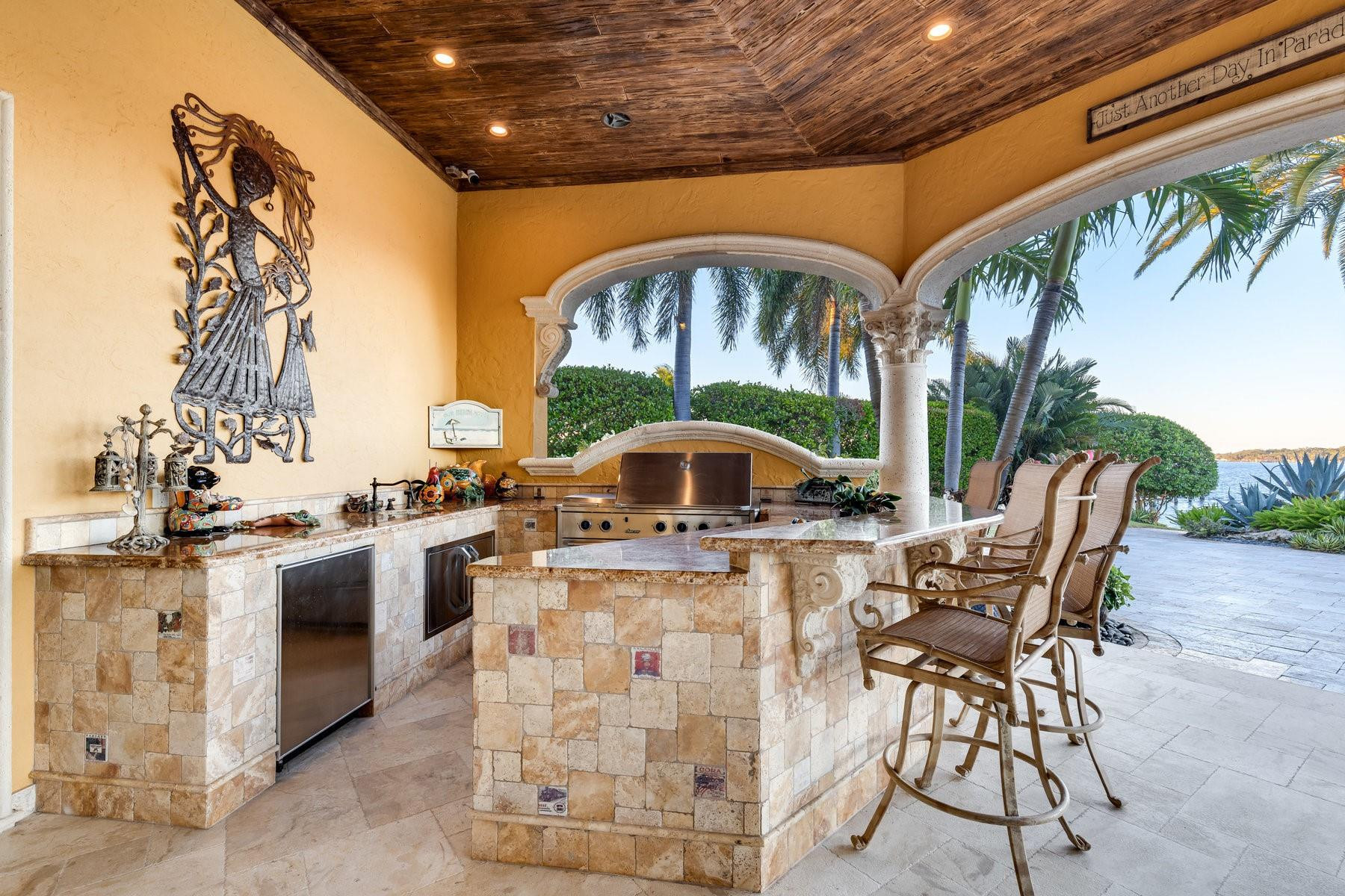 4089 Southeast Old St Lucie Boulevard Stuart, FL 34996 - Photo 84 of 99 a view of an chairs and tables in the patio