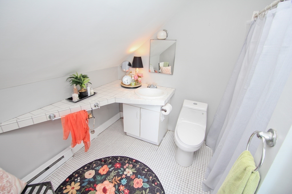 38 Virginia Street Springfield, MA 01108 - Photo 28 of 42 a bathroom with a sink mirror and toilet