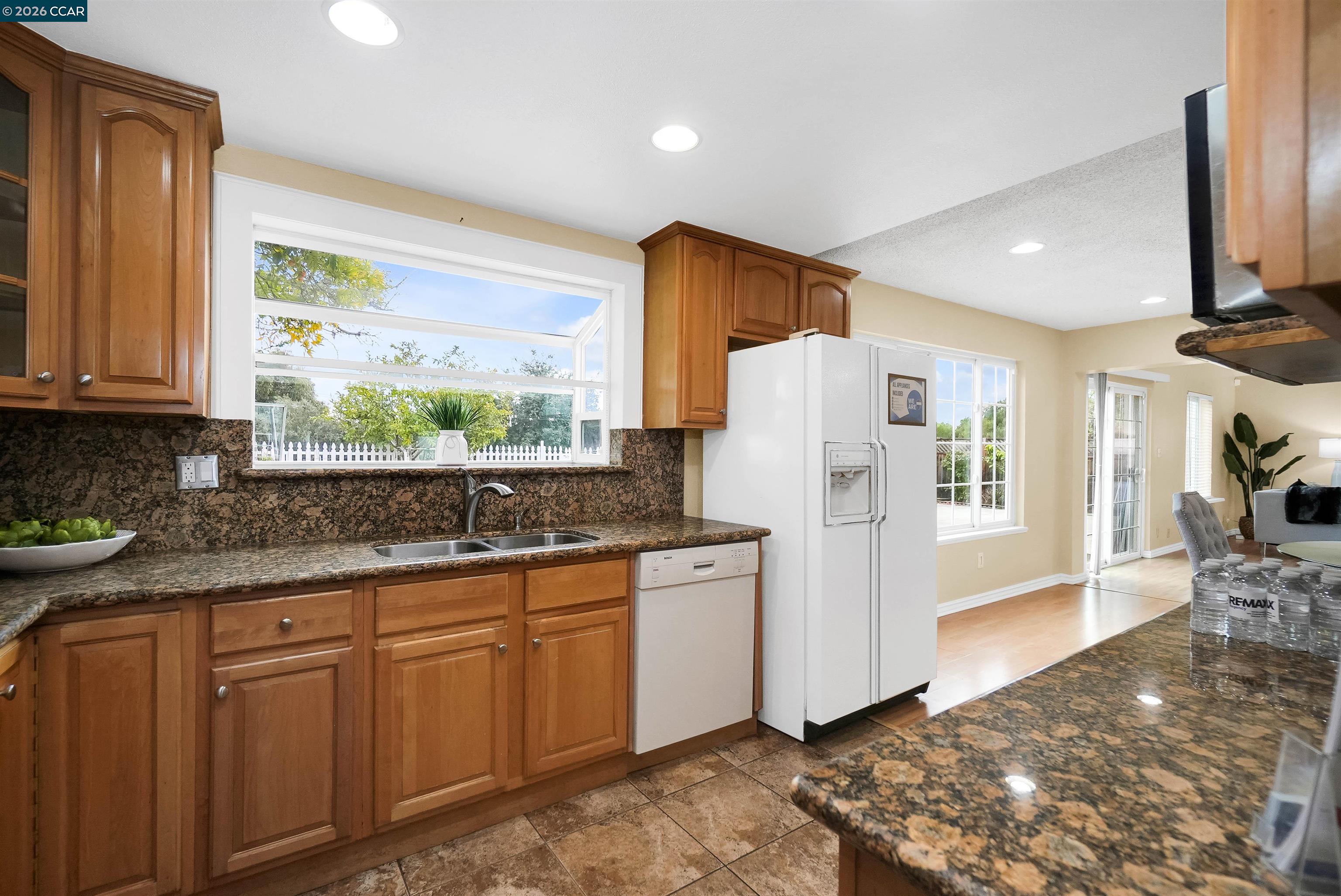 922 Coral Drive Rodeo, CA 94572 - Photo 26 of 59 a kitchen with granite countertop a refrigerator sink stove and cabinets