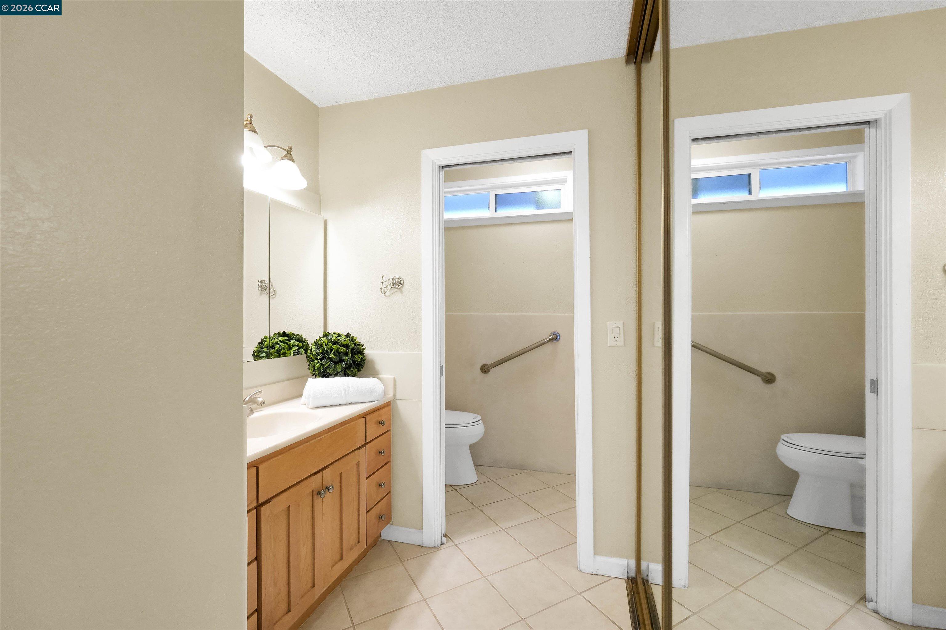 922 Coral Drive Rodeo, CA 94572 - Photo 38 of 59 a bathroom with a granite countertop toilet a sink and a shower