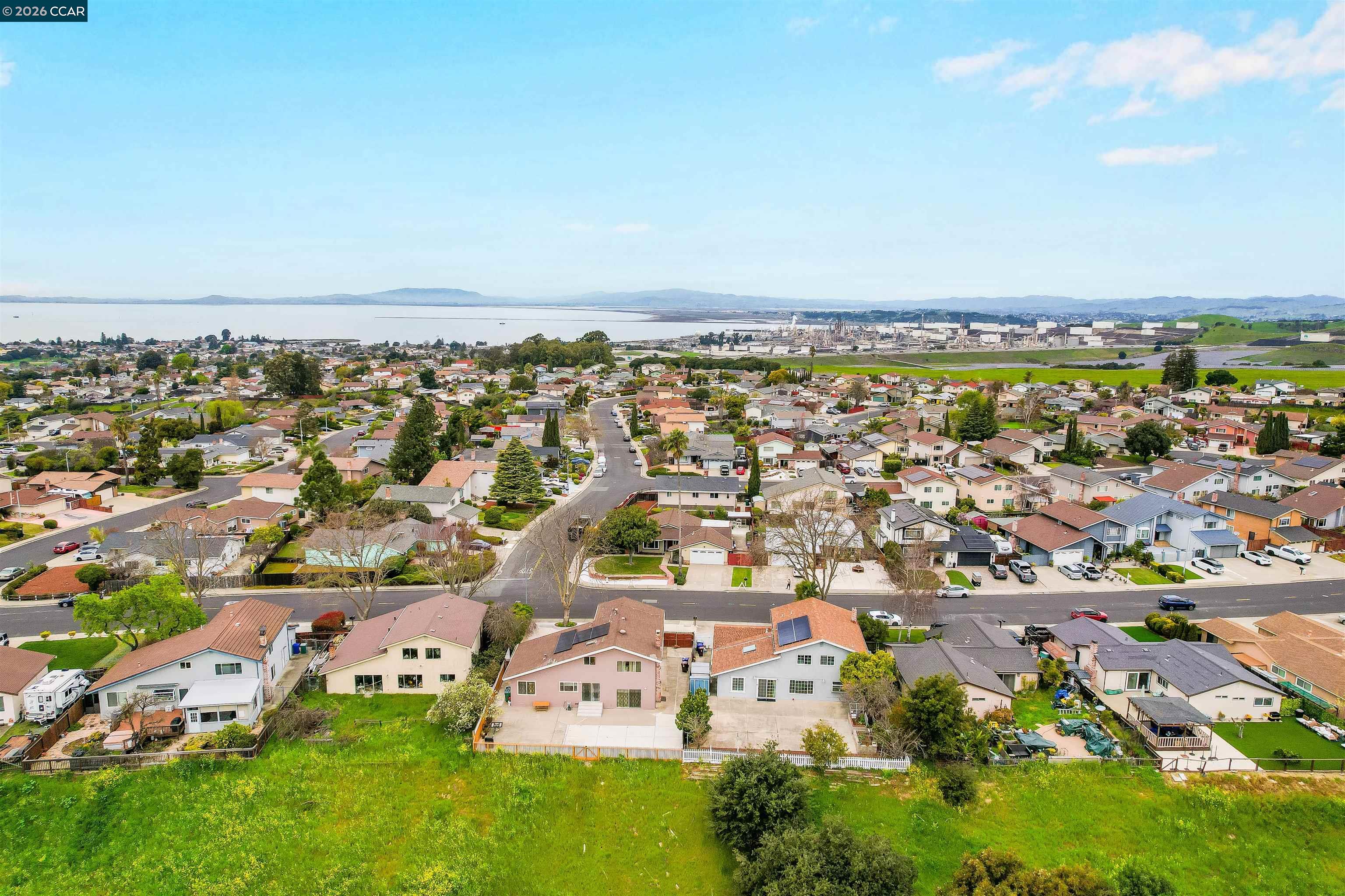 922 Coral Drive Rodeo, CA 94572 - Photo 53 of 59 an aerial view of a city with lots of residential buildings and ocean view in back
