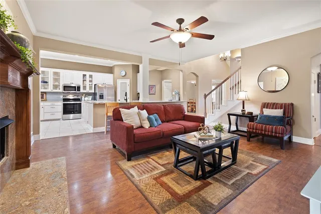 a living room with furniture a rug and a chandelier