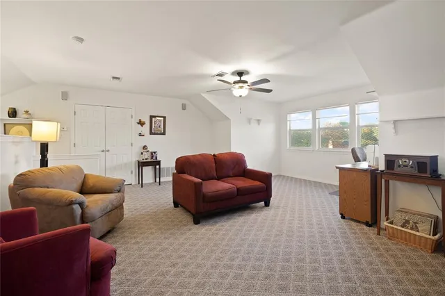 a living room with furniture a chandelier and a large window