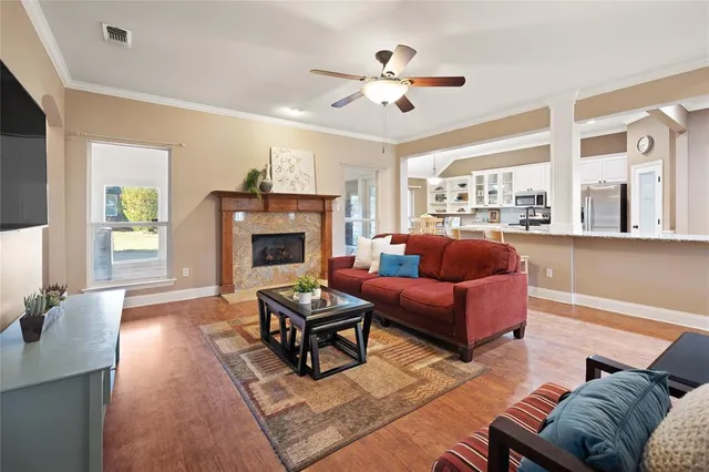 a living room with furniture a fireplace and a flat screen tv