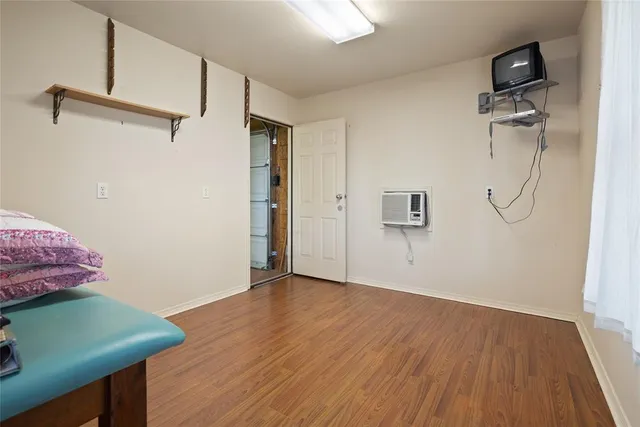 a view of a room with wooden floor and white walls