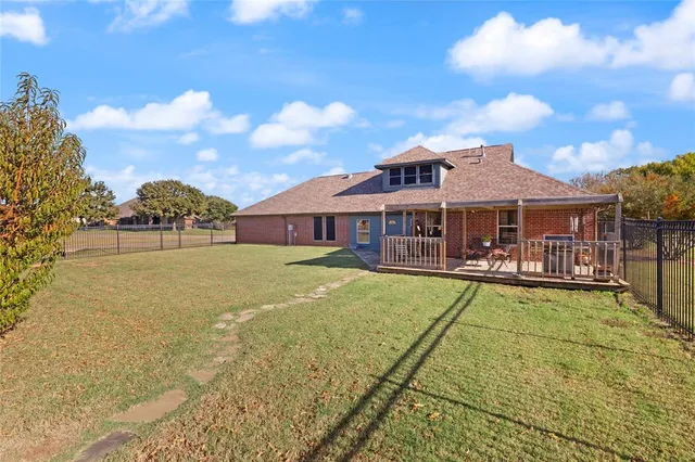 a view of a house with swimming pool and sitting area