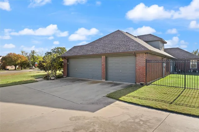 a view of a house with a backyard and a garage
