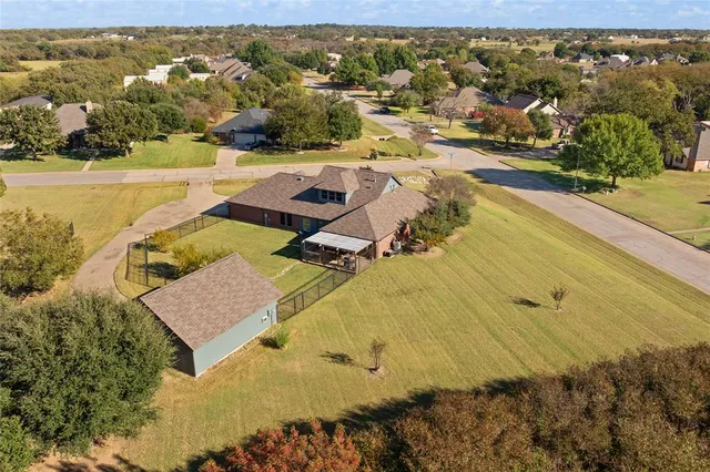 an aerial view of residential houses with outdoor space