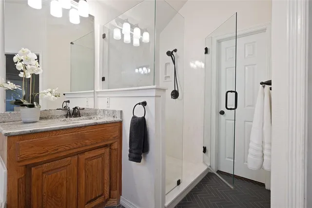 a bathroom with a sink vanity and a mirror