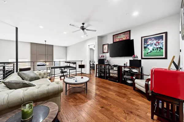 a living room with furniture and kitchen view