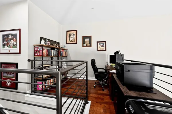 a living room with furniture and a flat screen tv with wooden floor