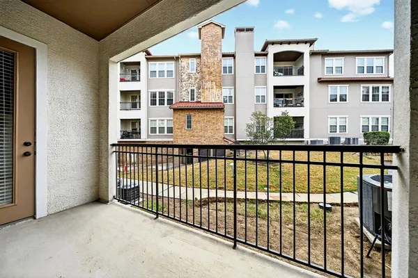 a view of swimming pool with outdoor seating and house in the background