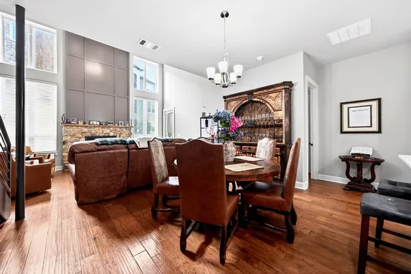 a view of a dining room with furniture wooden floor and chandelier