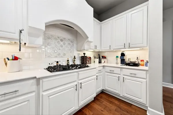 a kitchen with white cabinets and white appliances