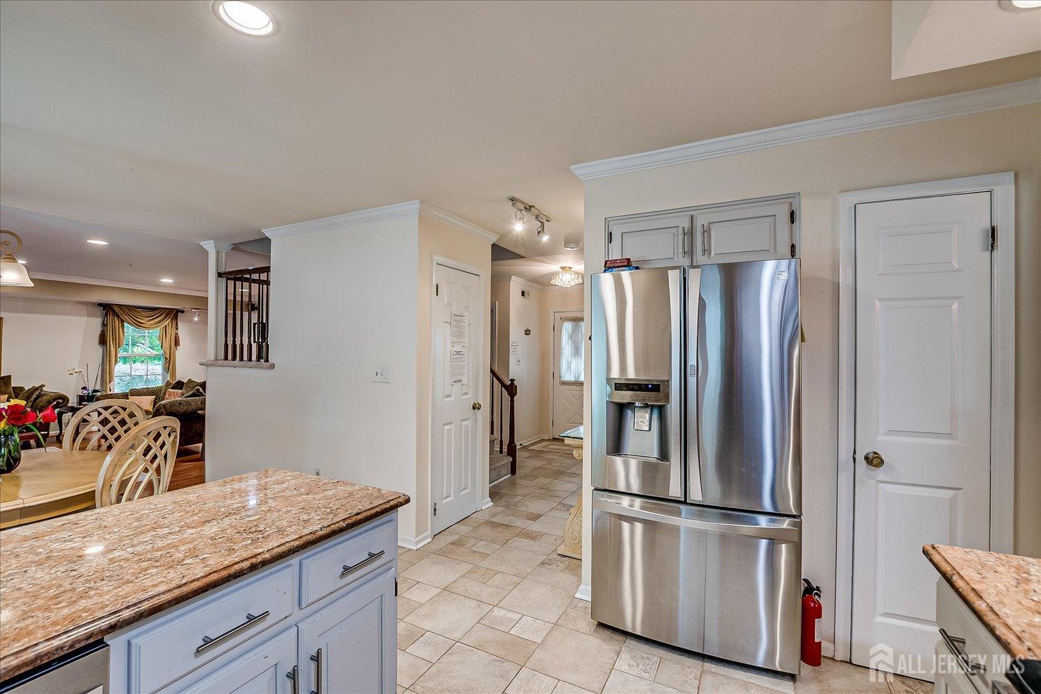 2 Pine Ridge Drive Edison, NJ 08820 - Photo 17 of 50 a kitchen with granite countertop a refrigerator and cabinets