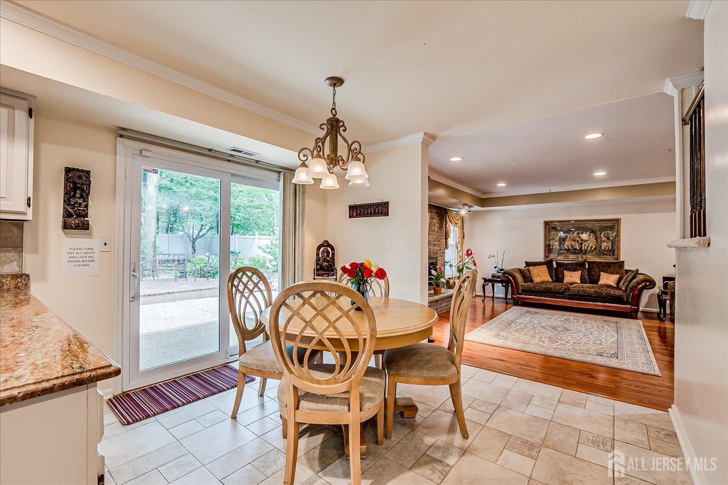 2 Pine Ridge Drive Edison, NJ 08820 - Photo 18 of 50 a dining room with wooden floor a chandelier a glass table and chairs