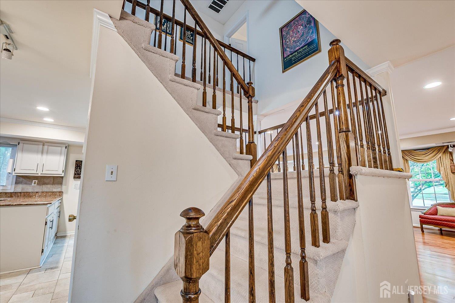 2 Pine Ridge Drive Edison, NJ 08820 - Photo 27 of 50 a view of staircase with lots of frames on wall and a window